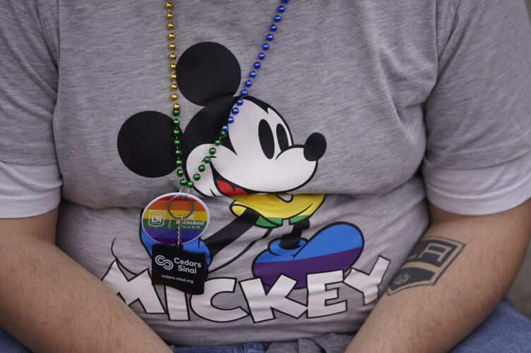 As Disney revs up for retail pride month, they're seeing a dramatic drop in theme park attendance (AP Photo/Damian Dovarganes)