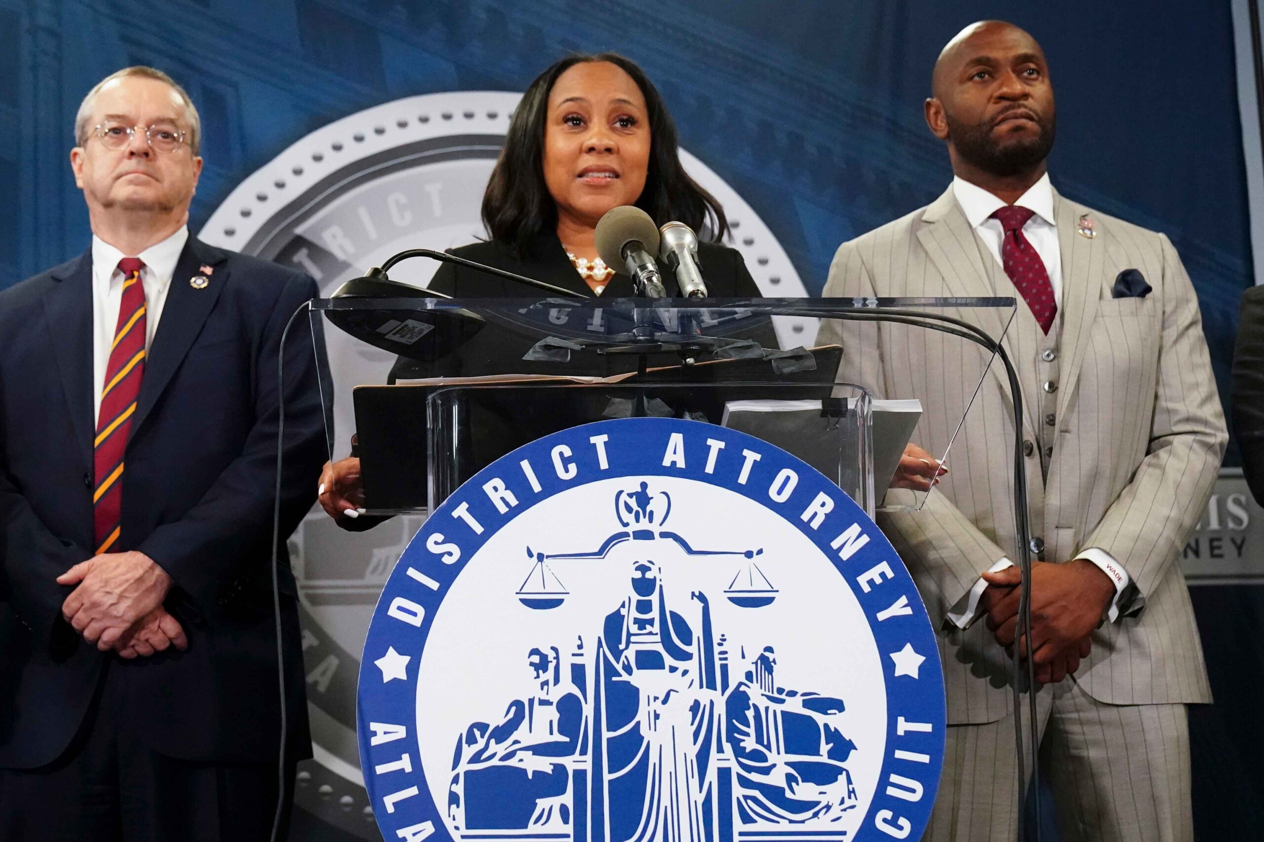 Fulton County District Attorney Fani Willis, center, speaks in the Fulton County Government Center during a news conference, Monday, Aug. 14, 2023, in Atlanta. Donald Trump and several allies have been indicted in Georgia over efforts to overturn his 2020 election loss in the state. (AP Photo/John Bazemore). Fulton County Court Clerk Ché Alexander admitted to accidentally uploading an indictment document against Donald Trump before a grand jury ruling.