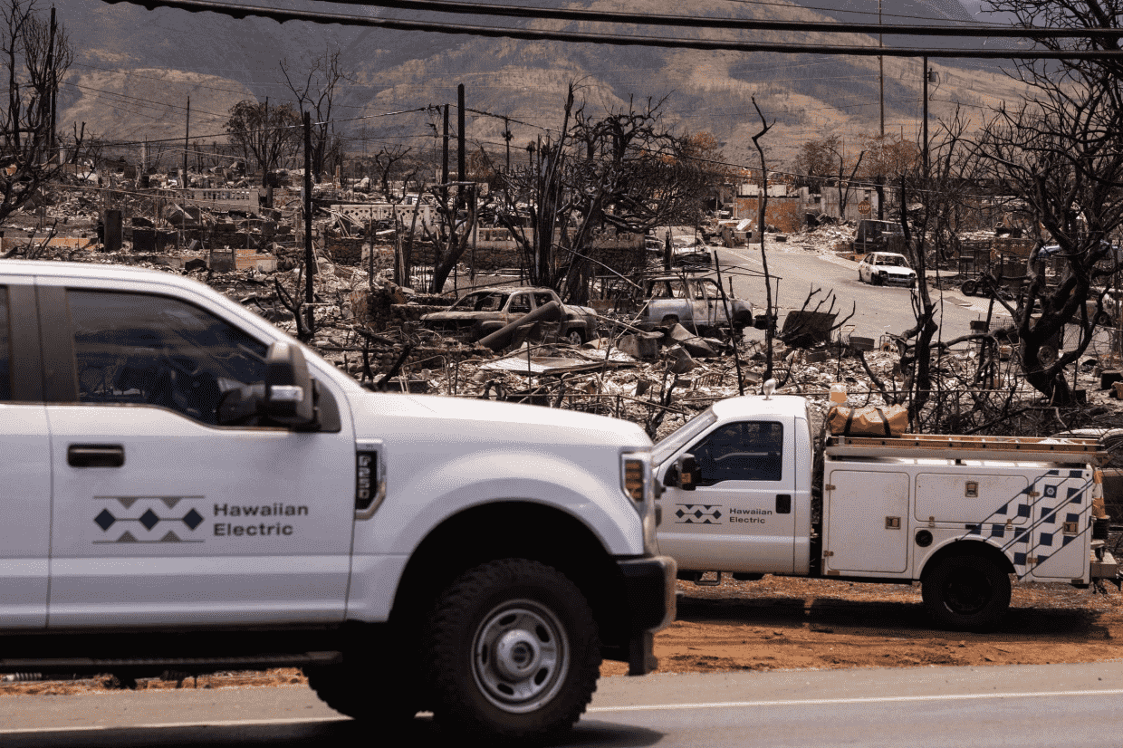 Hawaiian Electric trucks restore electric poles Wednesday after the Maui wildfires in Lahaina. Yuki Iwamura. | (AFP - Getty Images) Survivors of the Maui wildfire claim that the only road out of Lahaina was barricaded by officials and work crews as residents tried to escape.
