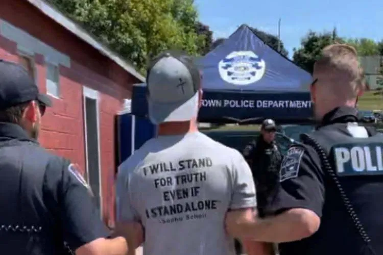 Video circulated on social media showing multiple police officers arresting the young preacher as he was reading from the Bible. (Image: Jason Storms.)
