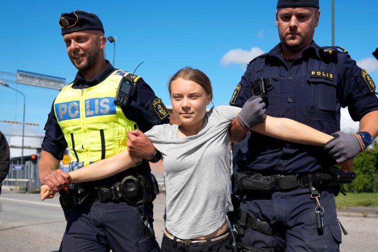 Swedish climate change activist Greta Thunberg has been charged a second time for disobeying a police order to leave a protest at a busy port in Sweden. AP Photo/Pavel Golovkin