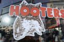 Hooters, known for its chicken wings and well-proportioned waitresses, is preparing to file for bankruptcy after suffering reduced traffic and growing debt.